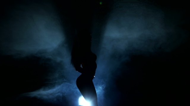 Dancing silhouettes of woman in a nightclub