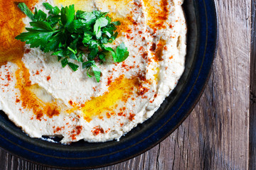Fresh hummus with parsley and oil.