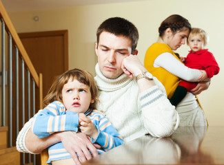 Couple with children in quarrel at home
