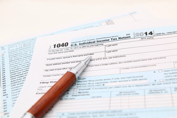 Income tax form and pen. Finance concept