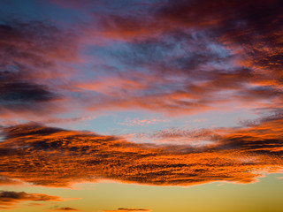 Tropical sunset with clouds in orange and the twilight sky