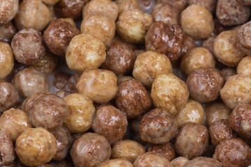 Chocolate and peanut butter puff ball cereal background