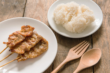Grilled pork and sticky rice on plate, Thai food style