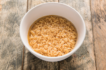 noodles in white dish on wooden background