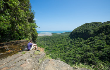 Man overlooking lush tropical Jungle in Okinawa