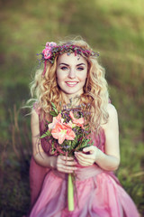 Beautiful blonde girl in a pink dress