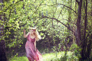 Girl in fairy dress walks in the woods