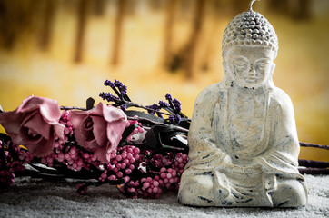 small sculpture of buddha over white pebbles