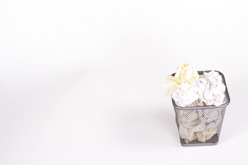 isolated wastebasket full of white waste paper