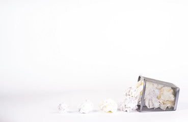 isolated wastebasket full of white waste paper