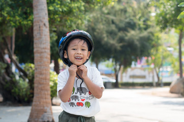 Happy child wearing a bike helmet outdoors