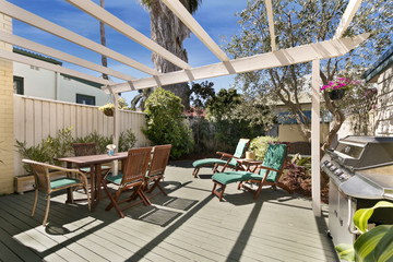 backyard cozy patio area with wicker furniture set