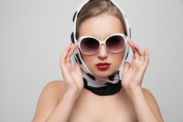 Stylish woman posing in sunglasses and scarf on head