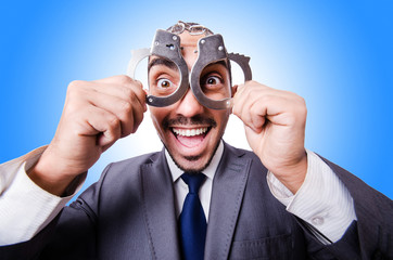 Funny businessman with handcuffs on white