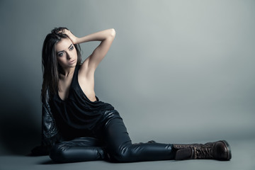 Fashion model wearing leather pants and jacket
