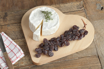 Camembert cheese with a twig of muscat raisins © Picture Partners