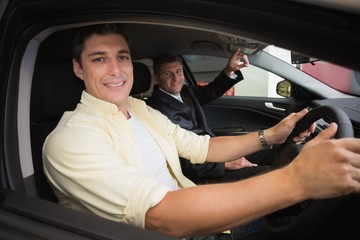 Fototapeta na wymiar Businessman pointing a car interior