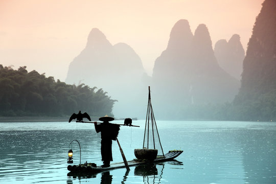 Fototapeta Chinese man fishing with cormorants birds