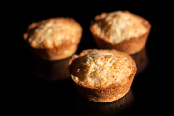 Three cupcakes on a black background
