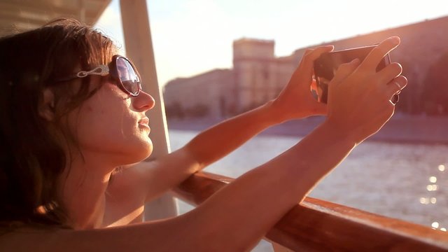 Young beautiful woman with sunglasses taking picture With