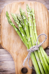 Asparagus on the wooden background.