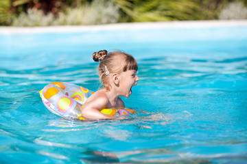 Fototapeta na wymiar Happy Little Girl In The Pool