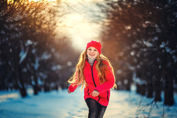 Beauty Teenager Girl Running in frosty winter Park. Outdoors. Su