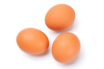 three brown eggs isolated on white