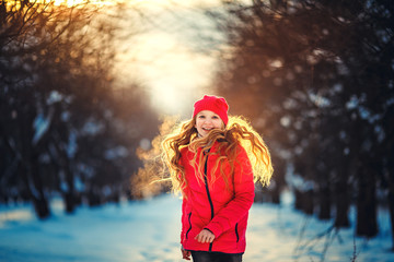 Beauty Teenager Girl Running in frosty winter Park. Outdoors. Su