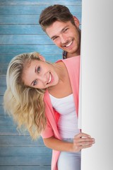 Composite image of attractive young couple smiling at camera