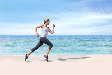 Fototapeta na wymiar Composite image of pretty fit blonde jogging