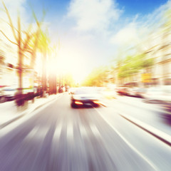 Fototapeta na wymiar Car in motion blur on the street at sunset.