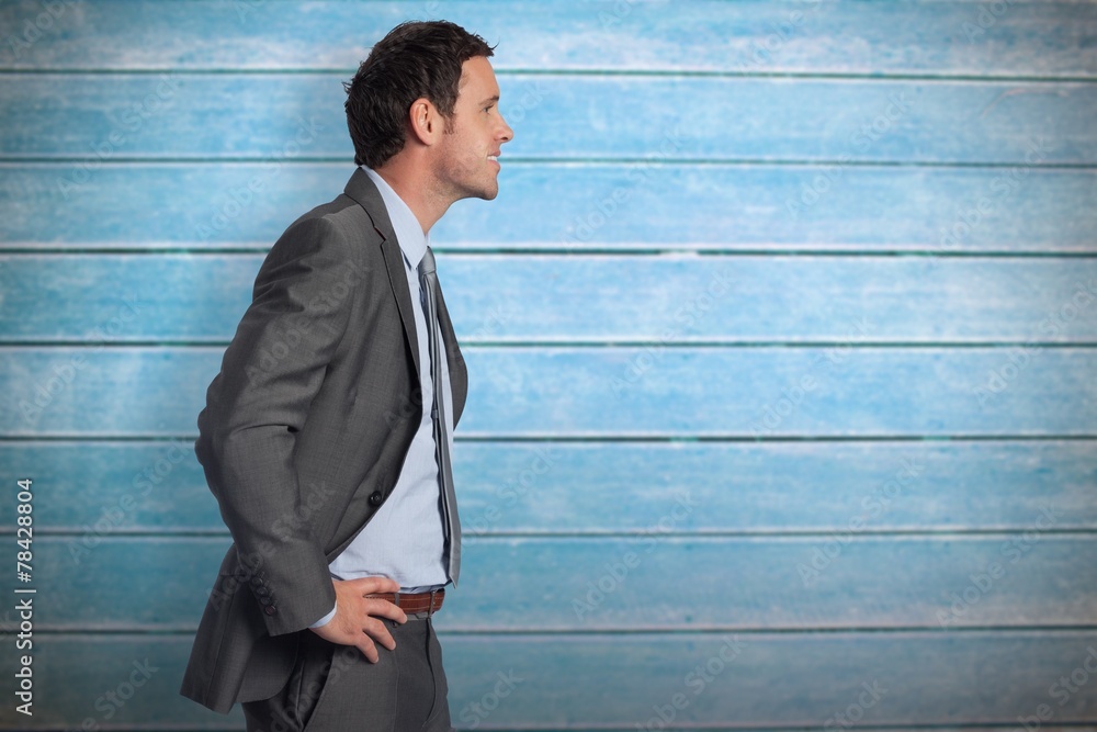 Poster composite image of smiling businessman with hands on hips