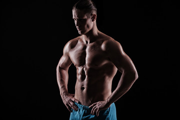 Fototapeta premium strong athletic man on black background