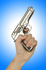 Naklejka premium Gun in the hand on white