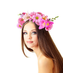 Obraz na płótnie Canvas Beautiful young woman with wreath of flowers