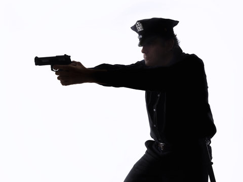 Silhouette of a policeman with the handgun on white background