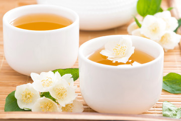 Green jasmine tea in white cups