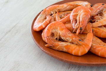 boiled shrimp with lemon arranged on a a plate