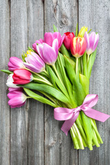 bouquet of spring tulips on old wooden background