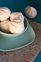 Delicate pink marshmallows lies in the blue plate