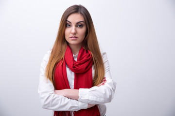 Portrait of a young woman with arms folded looking at camera