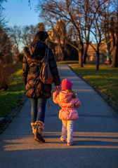 Fototapeta premium Mother and Daughter walk on a sunny winter day