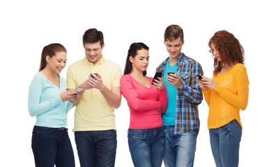 group of smiling teenagers with smartphones