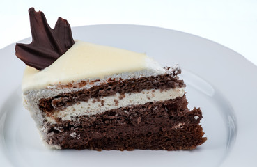 Slice of cake with chocolate and whipped cream with white chocol