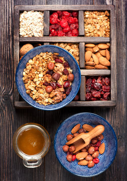 Granola, oatmeal, nuts, dried berries and honey. Healthy food
