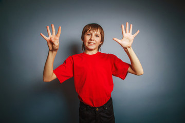 European-looking boy of ten years shows nine digit finger on a g