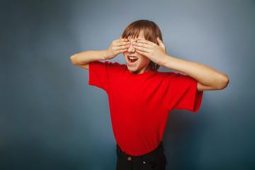 boy teenager European appearance in a red shirt closed eyes with
