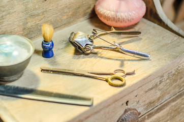antique hairdressing equipment on wooden background