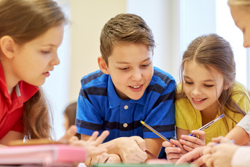 group of students talking and writing at school